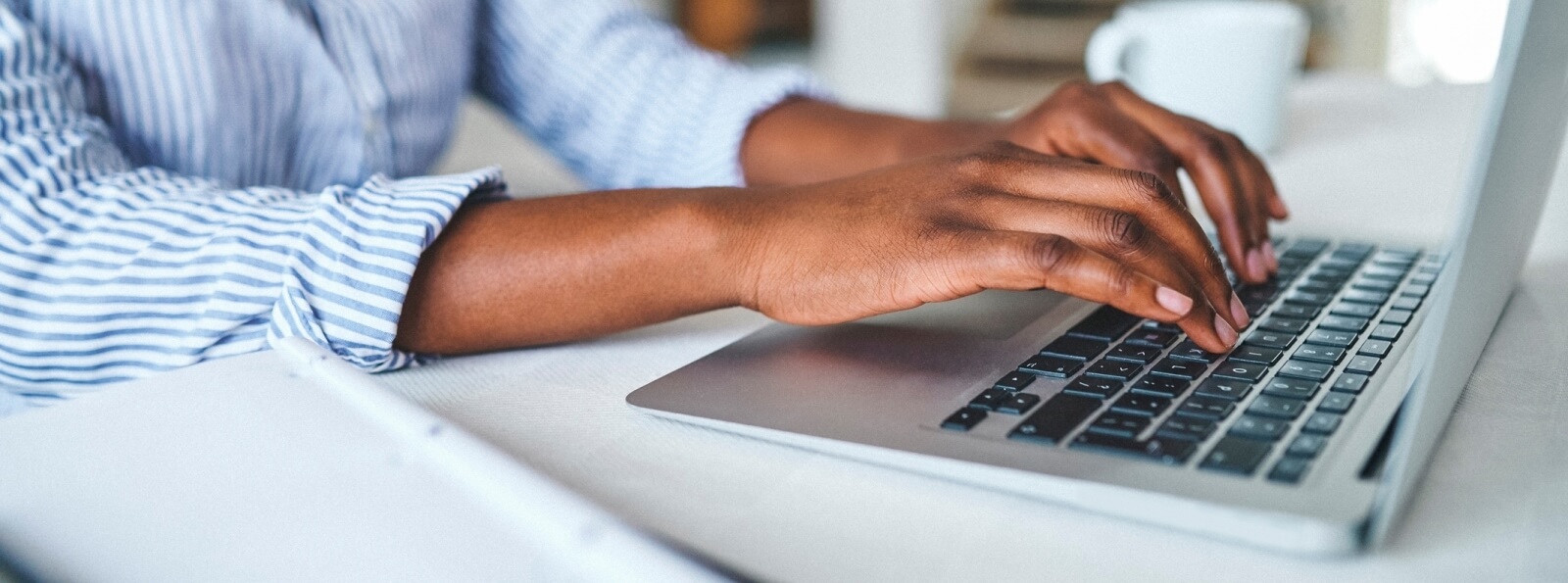 close-up of hands using a keyboard