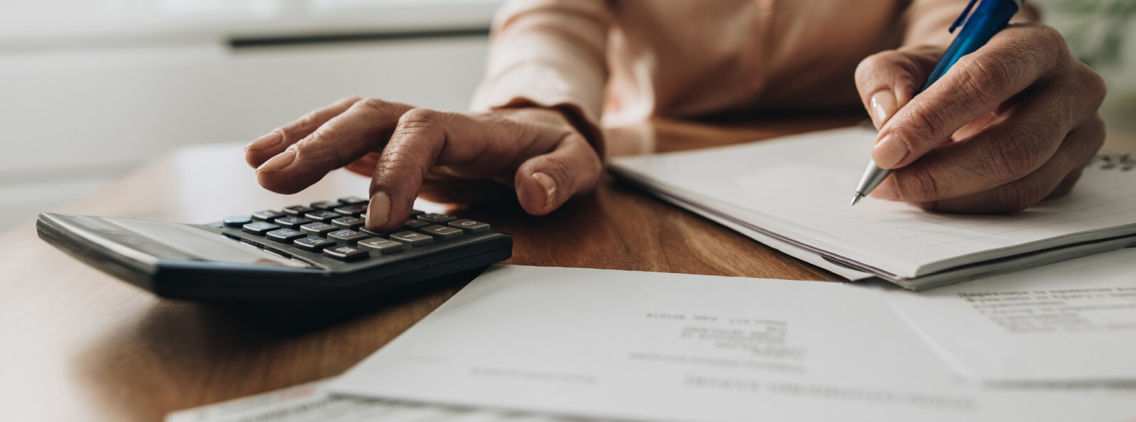 close-up of hands using a calculator
